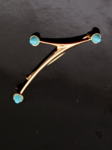 14 carat gold modern brooch with turquoises
